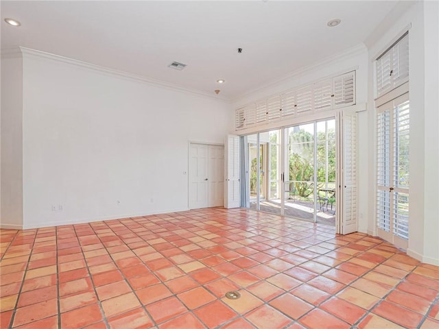 tiled spare room with crown molding