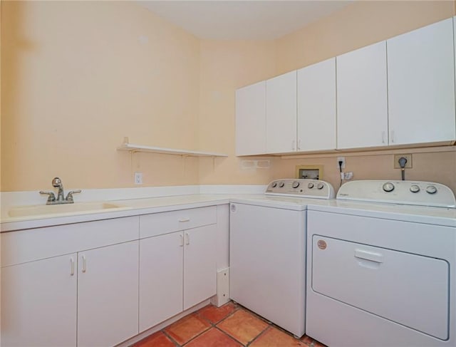 laundry area with washer and clothes dryer, light tile patterned floors, cabinets, and sink