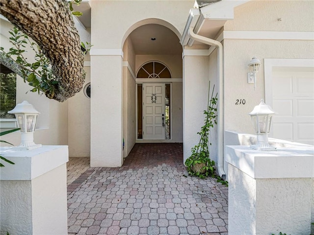 doorway to property with a garage