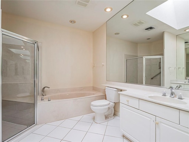 full bathroom with vanity, a skylight, tile patterned flooring, separate shower and tub, and toilet