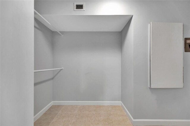 spacious closet with light tile patterned floors