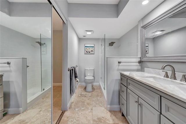 bathroom featuring tiled shower, vanity, and toilet