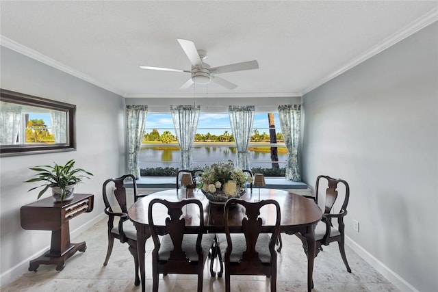 dining room featuring plenty of natural light, a water view, and ornamental molding