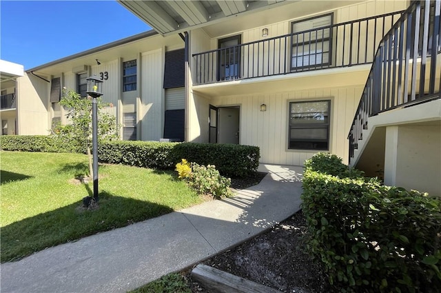 33 Plantation Dr Unit 104, Vero Beach, FL 32966 - view of exterior entry with a yard and a balcony
