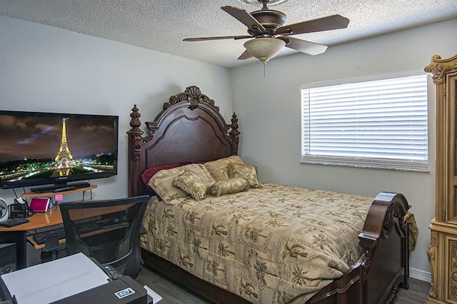 bedroom with ceiling fan, dark hardwood / wood-style floors, and a textured ceiling