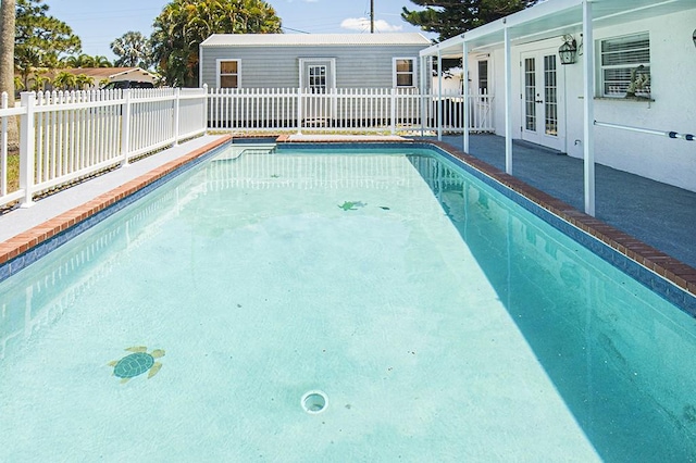 view of pool featuring french doors