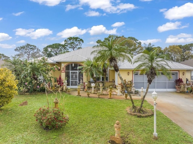 ranch-style home with driveway, a front lawn, an attached garage, and stucco siding