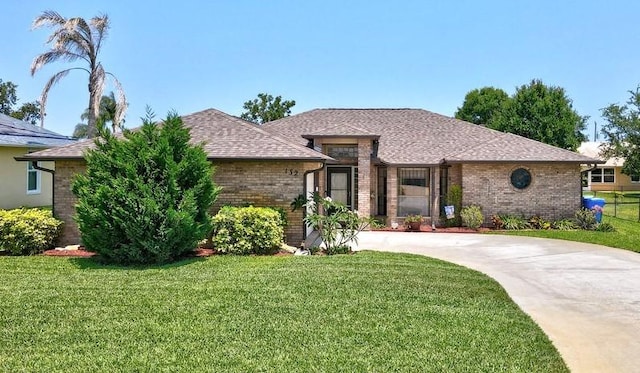 132 Keystone Dr, Sebastian, FL 32958 - view of front facade with brick siding, a front yard, and driveway