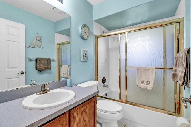 132 Keystone Dr, Sebastian, FL 32958 - bathroom featuring vanity, toilet, and shower / bath combination with glass door