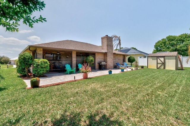 132 Keystone Dr, Sebastian, FL 32958 - rear view of property featuring a patio, a storage shed, an outdoor structure, and a lawn