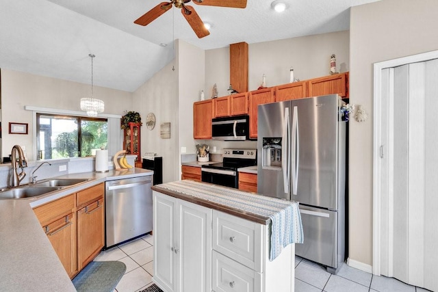 132 Keystone Dr, Sebastian, FL 32958 - kitchen with stainless steel appliances, a sink, light tile patterned floors, lofted ceiling, and light countertops