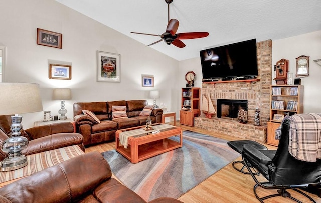132 Keystone Dr, Sebastian, FL 32958 - living area with wood finished floors, a ceiling fan, vaulted ceiling, and a fireplace