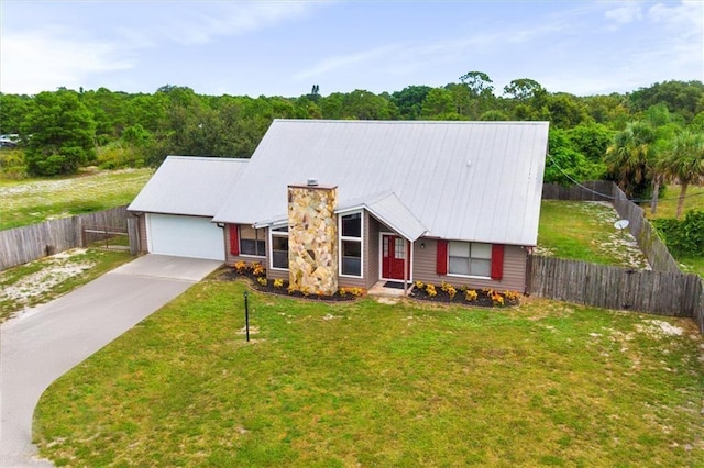 view of front of property featuring a garage and a front lawn