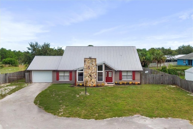 view of front of property featuring a garage and a front lawn