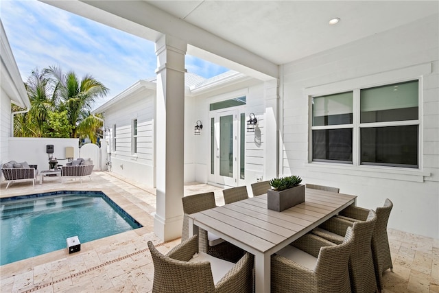 view of swimming pool featuring french doors and a patio