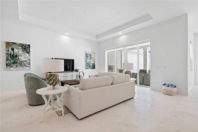 living room featuring a raised ceiling