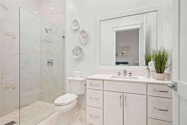20 Strand Dr, Vero Beach, FL 32963 - bathroom featuring a marble finish shower, toilet, and vanity