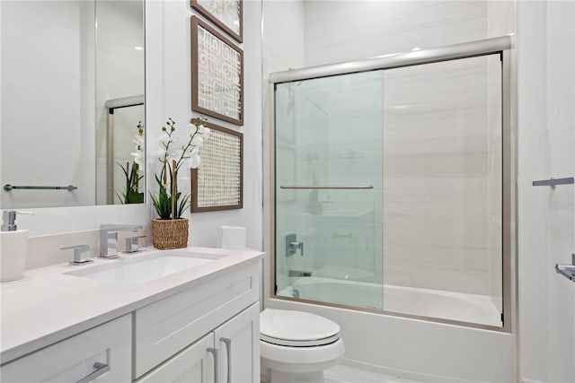 full bathroom with vanity, toilet, and bath / shower combo with glass door