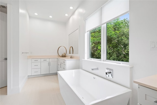 bathroom with vanity and a tub