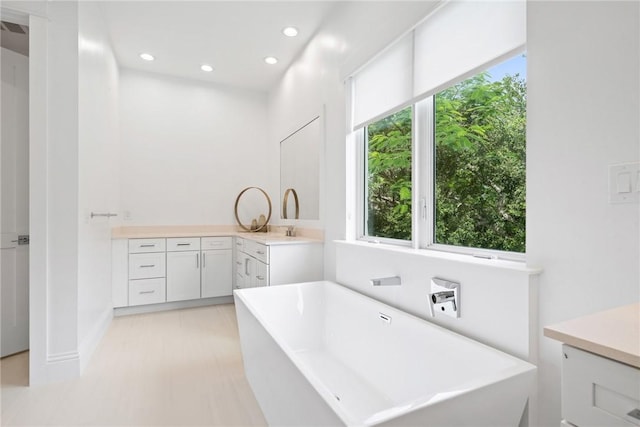 20 Strand Dr, Vero Beach, FL 32963 - full bath featuring a freestanding tub, vanity, recessed lighting, and baseboards