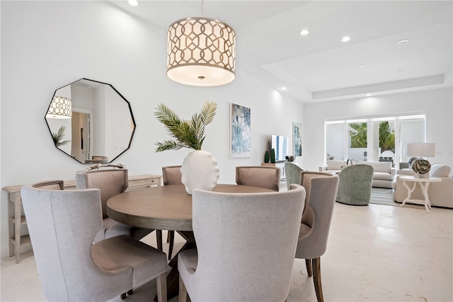 dining room with a raised ceiling