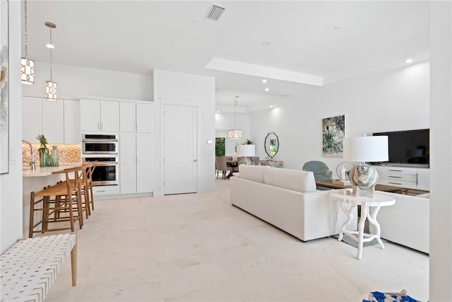 living room with a raised ceiling