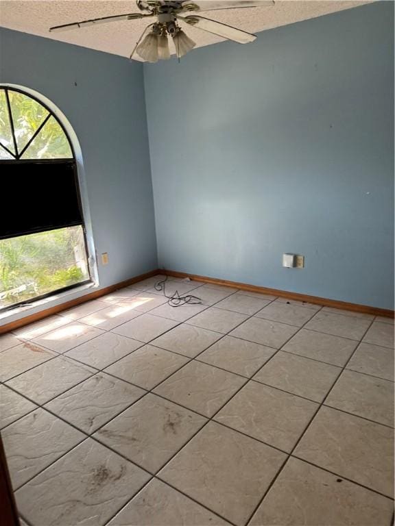 509 Breakwater Ter, Sebastian, FL 32958 - spare room featuring ceiling fan, a textured ceiling, and light tile patterned floors