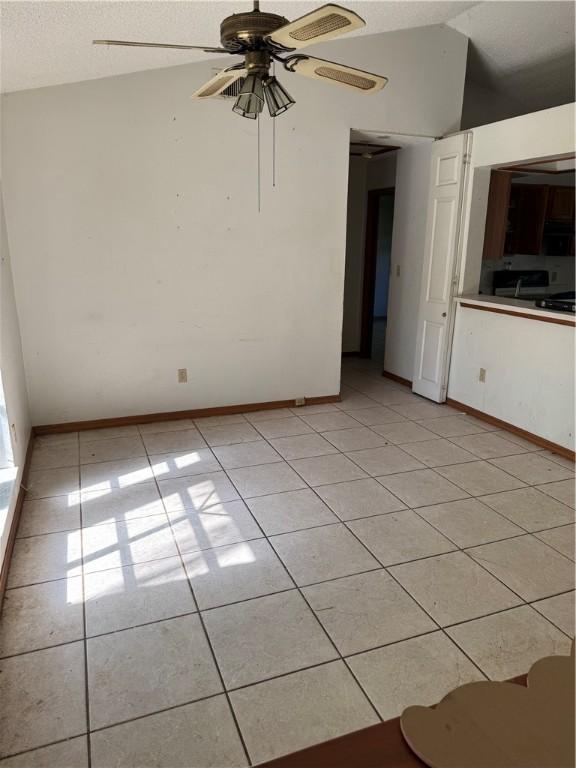 509 Breakwater Ter, Sebastian, FL 32958 - spare room with light tile patterned flooring, lofted ceiling, and a ceiling fan
