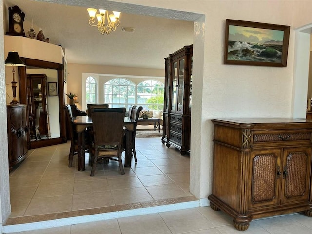 dining room featuring visible vents, a notable chandelier, and light tile patterned flooring