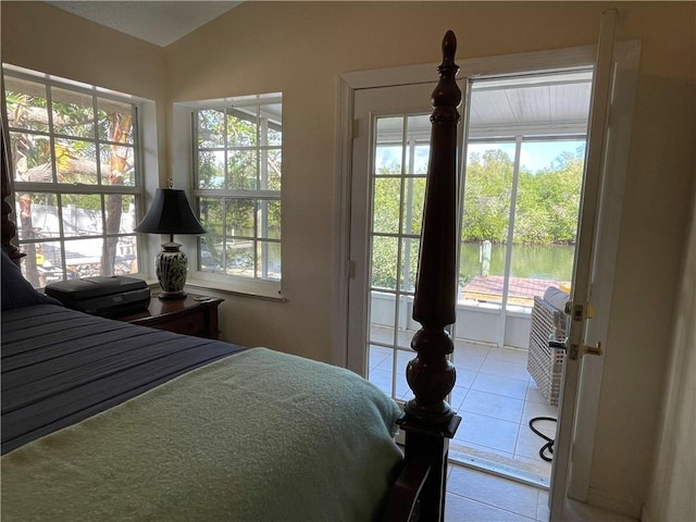 bedroom featuring lofted ceiling and light tile patterned flooring