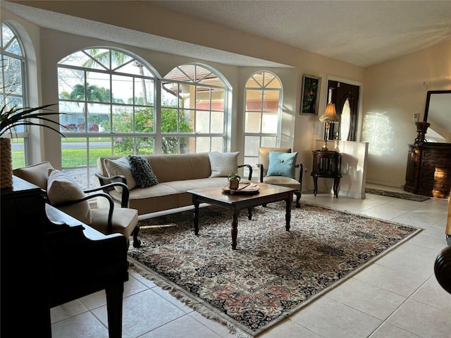 interior space with lofted ceiling, light tile patterned floors, and a textured ceiling