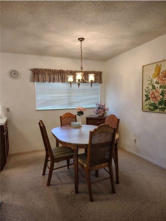 dining space with a chandelier, a textured ceiling, and carpet floors