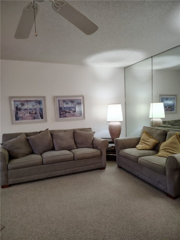 carpeted living room with a textured ceiling and ceiling fan