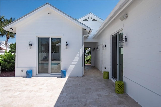 95 Strand Dr, Vero Beach, FL 32963 - back of property featuring a patio area and an attached garage