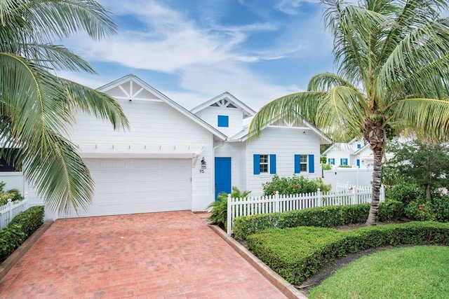 95 Strand Dr, Vero Beach, FL 32963 - view of front of home with a garage and decorative driveway