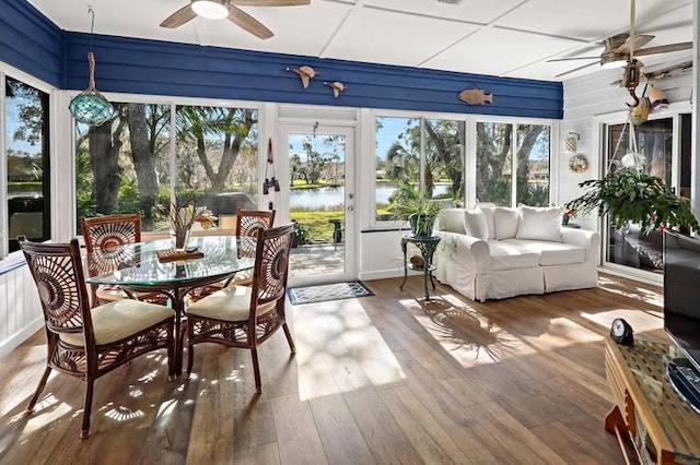 sunroom / solarium featuring ceiling fan