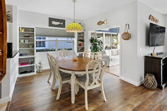 dining space featuring dark wood-type flooring