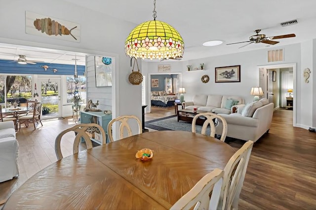 dining space with ceiling fan and hardwood / wood-style flooring