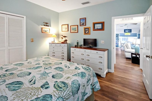 bedroom with hardwood / wood-style flooring and a closet