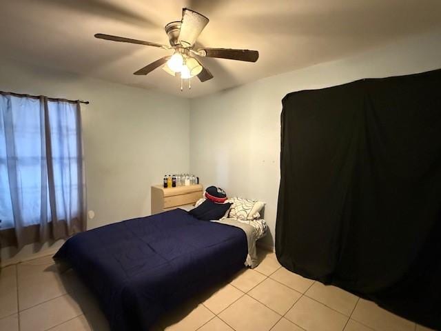 bedroom with ceiling fan and light tile patterned floors