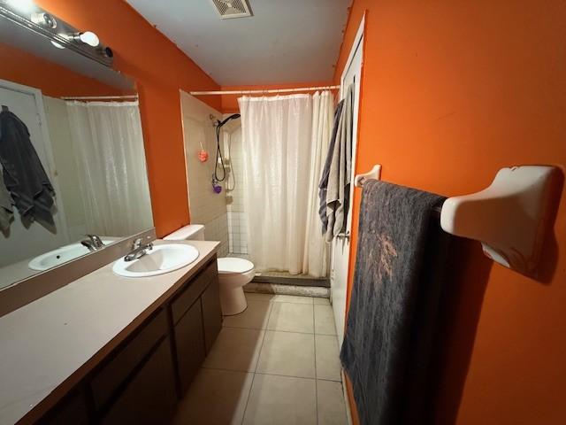 bathroom featuring tile patterned floors, toilet, and vanity