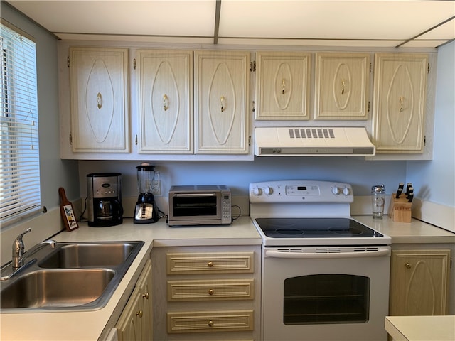 kitchen with light brown cabinets, white electric range, exhaust hood, and sink