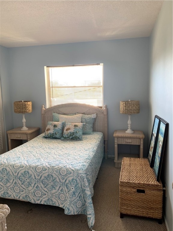 carpeted bedroom featuring a textured ceiling