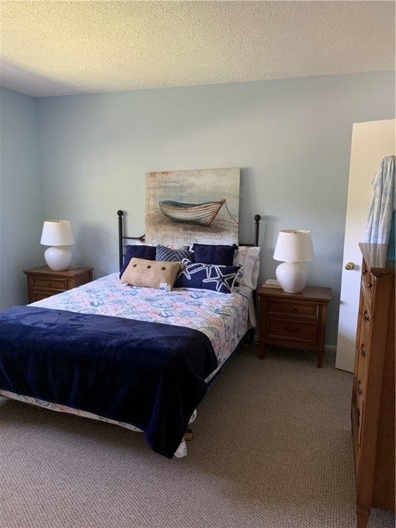 bedroom featuring a textured ceiling and carpet