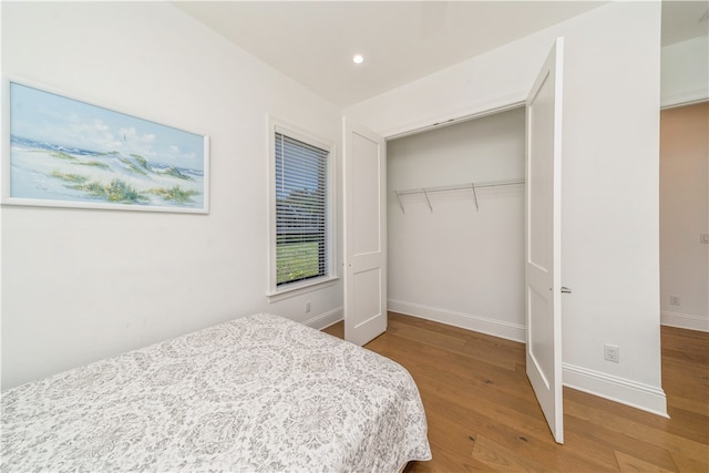 bedroom with hardwood / wood-style floors and a closet