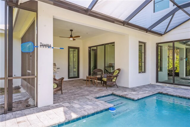 view of pool featuring a patio, a lanai, and ceiling fan