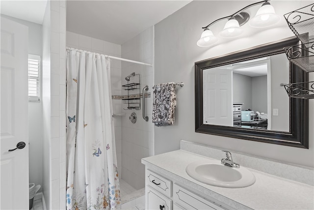 bathroom featuring walk in shower and vanity