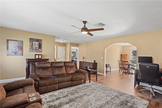 living room with ceiling fan and light hardwood / wood-style flooring