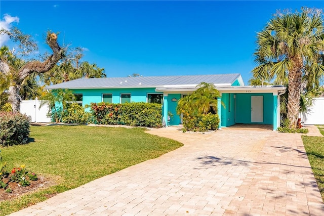 ranch-style home featuring a front yard and a carport