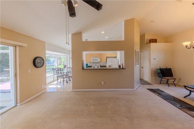 unfurnished living room featuring ceiling fan, light carpet, and a healthy amount of sunlight